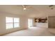 Bright living room featuring an open floor plan, neutral carpet and large windows at 17174 Se 76Th Caledonia Ter, The Villages, FL 32162