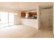 Bright, open living room features an adjacent kitchen and sliding glass doors to the backyard at 17174 Se 76Th Caledonia Ter, The Villages, FL 32162