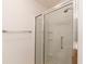 Bathroom featuring a glass enclosed shower with grab bar and built-in shelves at 17174 Se 76Th Caledonia Ter, The Villages, FL 32162