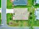 Aerial view of a single-story home showcasing the roof, landscaping, and surrounding neighborhood at 1723 Townsend Ter, The Villages, FL 32162