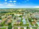 Beautiful aerial view of a home in a golf community with lush landscaping and serene water features at 1723 Townsend Ter, The Villages, FL 32162