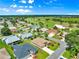 Aerial view of a residential neighborhood with golf course, lush greenery, and well-maintained homes at 1723 Townsend Ter, The Villages, FL 32162