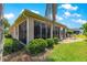 Inviting patio area with outdoor seating, complemented by lush landscaping, set against a backdrop of palm trees at 1723 Townsend Ter, The Villages, FL 32162