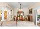 Dining room with carpeted floor and view of the kitchen, living room, and entryway at 1723 Townsend Ter, The Villages, FL 32162