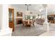 Dining room with fireplace, carpeted floors and a view into the living room with lots of natural light at 1723 Townsend Ter, The Villages, FL 32162