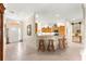 Open concept home with an entryway that leads to a kitchen with a breakfast bar and tile flooring at 1723 Townsend Ter, The Villages, FL 32162