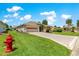 Well-maintained single-story home with a two-car garage, lush lawn, and manicured landscaping at 1723 Townsend Ter, The Villages, FL 32162