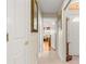 Welcoming hallway with neutral tones, tile flooring, and decorative mirror, leading to various rooms in the house at 1723 Townsend Ter, The Villages, FL 32162