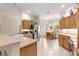 Well-lit kitchen featuring stainless steel appliances, wooden cabinets, and a breakfast nook with large windows at 1723 Townsend Ter, The Villages, FL 32162