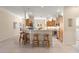 Spacious kitchen featuring a breakfast bar with seating, wood cabinets, stainless appliances and tiled flooring at 1723 Townsend Ter, The Villages, FL 32162