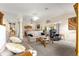 Bright living room with neutral walls, comfortable seating, carpeted floors and lots of natural light at 1723 Townsend Ter, The Villages, FL 32162