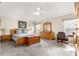 Spacious main bedroom with a large bed, wooden furniture, ceiling fan, and carpet flooring at 1723 Townsend Ter, The Villages, FL 32162