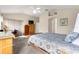 Bright main bedroom with vaulted ceiling, carpet floors, wooden desk, and large windows at 1723 Townsend Ter, The Villages, FL 32162