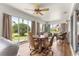 Bright sunroom with wood floors, tan curtains, and large windows offering natural light and pleasant views at 1723 Townsend Ter, The Villages, FL 32162
