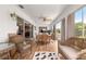 Bright sunroom featuring wood floors, wicker furniture, ceiling fan, and large windows with view of the backyard at 1723 Townsend Ter, The Villages, FL 32162