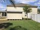 Private backyard with a shed, surrounded by a white fence at 1730 Ridgemoor Dr, Mascotte, FL 34753
