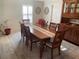Cozy dining room featuring traditional wood furniture, area rug, and neutral wall decor at 1730 Ridgemoor Dr, Mascotte, FL 34753