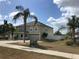 Two-story home featuring arched windows, a two-car garage, and lush palm trees enhancing its curb appeal at 1730 Ridgemoor Dr, Mascotte, FL 34753