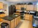 Well-equipped kitchen with a center island, stainless steel appliances, and ample cabinet space at 1730 Ridgemoor Dr, Mascotte, FL 34753
