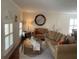 Inviting living room with hardwood floors, shutters, ample seating, and a decorative mirror at 1730 Ridgemoor Dr, Mascotte, FL 34753