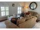 Comfortable living room with natural light, plush seating, and stylish decor at 1730 Ridgemoor Dr, Mascotte, FL 34753