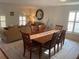Dining room with hardwood table and chairs, flowing into a comfortable living room area at 1730 Ridgemoor Dr, Mascotte, FL 34753