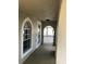 Covered porch featuring white accents, arched windows, and views of the outdoors at 1730 Ridgemoor Dr, Mascotte, FL 34753