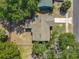 Aerial view of the house showing the roof, fenced backyard, and proximity to trees at 1905 Selleen Dr, Eustis, FL 32726