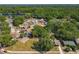 Aerial perspective of homes near a lake and playground in a leafy suburban neighborhood at 1905 Selleen Dr, Eustis, FL 32726