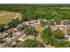 Aerial view of a residential area with houses, roads, and green spaces extending towards the horizon at 1905 Selleen Dr, Eustis, FL 32726