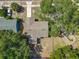 Aerial view of the house showing the roof, backyard, and nearby playground surrounded by trees at 1905 Selleen Dr, Eustis, FL 32726