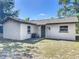 Exterior of a well-maintained home, featuring a neutral color palette and a compact backyard at 1905 Selleen Dr, Eustis, FL 32726