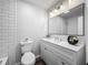 Updated bathroom features new vanity with a large mirror and modern fixtures at 1905 Selleen Dr, Eustis, FL 32726