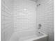 Bathroom features white subway tile, a shower and tub combination, and modern fixtures at 1905 Selleen Dr, Eustis, FL 32726