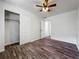 This bedroom features wood-look floors, a ceiling fan, and closet with traditional bi-fold doors at 1905 Selleen Dr, Eustis, FL 32726