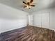 Bright bedroom featuring wood-look floors, a ceiling fan, and double door closet for plenty of storage at 1905 Selleen Dr, Eustis, FL 32726