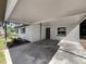 Exterior shot showcasing a covered carport with painted brick and concrete flooring leading to the front door at 1905 Selleen Dr, Eustis, FL 32726