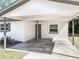 Carport and main entrance offering shelter and convenient access to the home's front door at 1905 Selleen Dr, Eustis, FL 32726