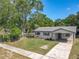 Charming single-story home with a well-maintained lawn and a covered front porch at 1905 Selleen Dr, Eustis, FL 32726