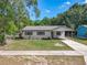 Single-story home with a well-manicured lawn, gray exterior paint, and a covered front porch at 1905 Selleen Dr, Eustis, FL 32726