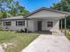 Inviting home exterior with a carport, manicured lawn, and garden beds, offering a blend of comfort and curb appeal at 1905 Selleen Dr, Eustis, FL 32726