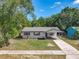 Charming home featuring a well-maintained front yard and a convenient covered carport entrance at 1905 Selleen Dr, Eustis, FL 32726