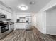 Bright, spacious kitchen with stainless steel appliances, modern white cabinets, and attractive flooring at 1905 Selleen Dr, Eustis, FL 32726