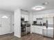Well-lit kitchen features stainless steel appliances, granite countertops and sleek, white cabinetry at 1905 Selleen Dr, Eustis, FL 32726
