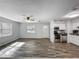 Open-concept living room features updated flooring, ceiling fan and lots of natural light at 1905 Selleen Dr, Eustis, FL 32726