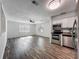 Open-concept living space with wood floors, modern lighting, and stainless steel appliances at 1905 Selleen Dr, Eustis, FL 32726