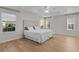 Bright bedroom with large windows and wood look floors at 2124 Hames Ln, The Villages, FL 32162