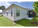 Home exterior featuring a screened-in porch, vinyl siding, and verdant grass at 2124 Hames Ln, The Villages, FL 32162