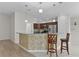Bright kitchen with stainless appliances and bar seating at 2124 Hames Ln, The Villages, FL 32162