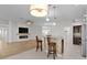Open kitchen view featuring counter seating, modern appliances, and view of the living room fireplace at 2124 Hames Ln, The Villages, FL 32162
